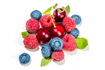Mix of isolate blueberry, blackberry, raspberry, cherry and mint. Fresh ripe berry set isolated on white background