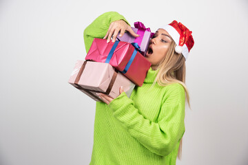Young woman carrying festive Christmas presents