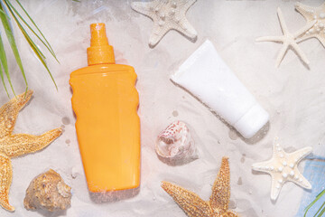 Sunscreen suncare background. Mockup background with vacation accessory, suntan lotion bottle, cosmetic cream, with seashells, straw woman's hat with sun glasses, top view copy space