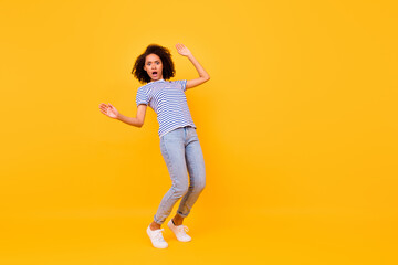 Fototapeta na wymiar Full length portrait of terrified impressed girl stand tiptoe balancing empty space abyss isolated on yellow color background