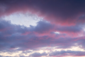 Beautiful sunset sky. Clouds illuminated by red sunlight at sunset. This view of the sky with clouds at sunset is great for background and design.