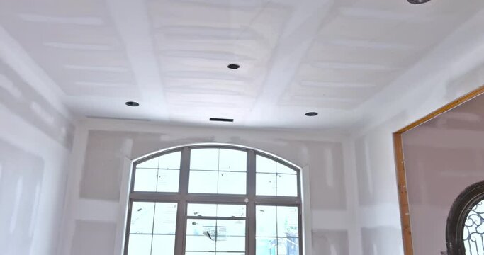 A newly constructed house is using the finishing putty applied to prepare painted to its walls