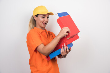 Pizza delivery woman opening pizza box with happy face on white background