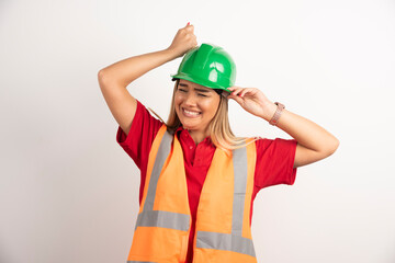 Smiling engineer female wear uniform with hard green helmet on white background