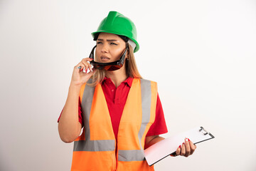 Female constructor looking away and wearing goggles