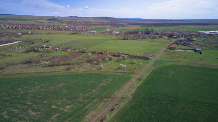 Fototapeta na wymiar Aerial photography from a drone. View of the fields and the village from a height panoramic view