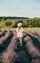 portrait of a young blonde girl in a lavender field in the summer at sunset