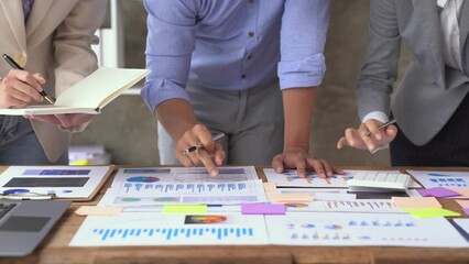 Financial analyst analysis business financial report on graph document and laptop during a discussion at corporate showing the results of their successful teamwork, business meeting concept, Marketing