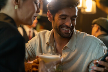 Caucasian man and woman using mobile phone together while hangout nightlife party at restaurant bar. Attractive female romantic dating with boyfriend celebrating holiday event together at nightclub