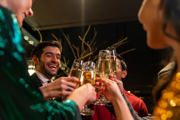 Group of Diversity people celebrating and toasting champagne glass together at luxury restaurant bar. Happy man and woman friends enjoy and fun holiday hangout party meeting nightlife at nightclub