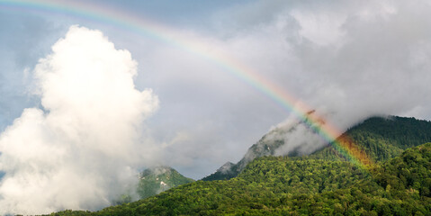 Panoramic view of rainbow and mountains