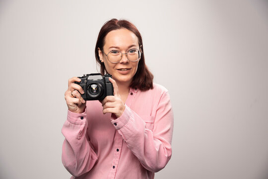 Woman Taking A Picture With Camera On White Background