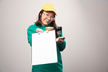 Deliverywoman holding cardboard of coffee cups on a white background