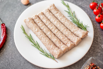 raw turkey sausages on stone background