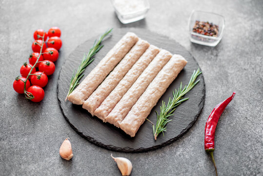  raw turkey sausages on stone background