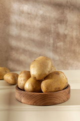 Raw potatoes in a bowl. The concept of harvesting, organic food.