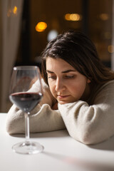 alcoholism, alcohol addiction and people concept - drunk woman or female alcoholic drinking red wine at home