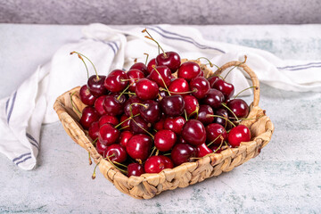 Fresh cherry. Ripe cherries in a basket on a stone background. Bulk cherries. close up
