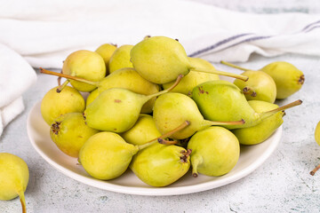 Fresh pear. Ripe pears in plate on stone background. Bulk pear. close up