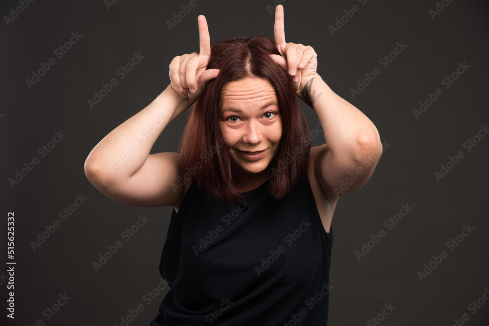 Wall mural Female model in black shirt making scary pose - Wall murals