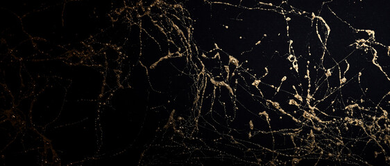 Gold and black marble art pattern. Textured abstract background.