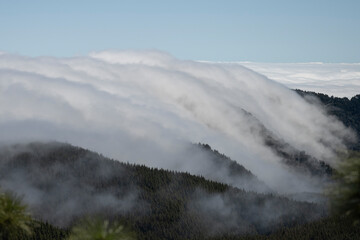 Fog flows down the mountain