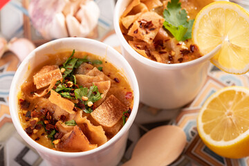 Mediterranean traditional Moroccan lentil soup garnished with flatbread, chilli and coriander