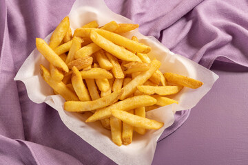 Fries portion on soft violet background