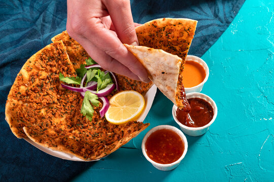 Traditional Moroccan pizza flatbread topped with red lentils and herbs served with dips