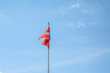 Fototapeta premium Flag with Lithuanian herb, blue sky in the background