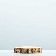 Wood slice podium on blue background for cosmetic product mockup