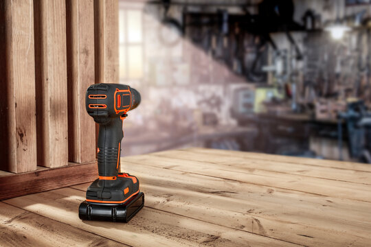 Screwdriver on table and interior of workshop. Empty space for your decoration. 