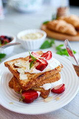 Breakfast of french toast with strawberries and maple syrup, good morning..