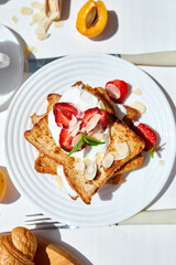 Breakfast of french toast with strawberries and maple syrup, good morning..