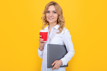Fototapeta premium smiling blonde woman with coffee cup and laptop on yellow background