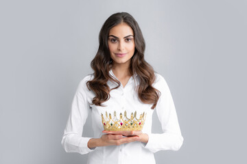 Portrait of young lovely expression woman in crown, isolated studio portrait.