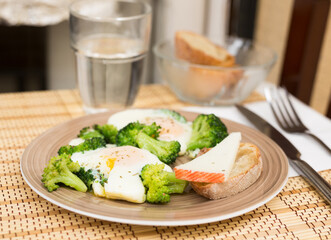 breakfast of crumpled eggs with broccoli
