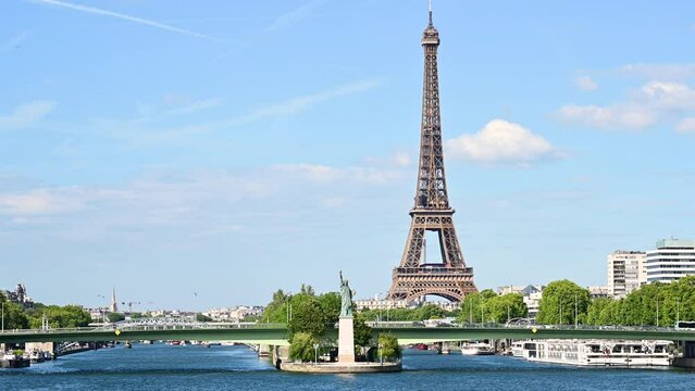 Paris,France.June 2022.Amazing footage that collects two symbols of France: the Eifell tower and the statue of liberty at the base.An iconic image of the city on a beautiful summer day. Static framing