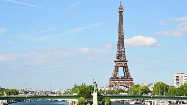 Paris,France.June 2022.Amazing footage that collects two symbols of France: the Eifell tower and the statue of liberty at the base.An iconic image of the city on a beautiful summer day. Static framing
