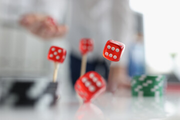 Closeup of person throwing dice. Addiction to gambling concept