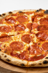 italian pizza with salami on a white background