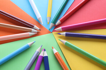 Fototapeta premium Multi-colored pencils on colored paper on table