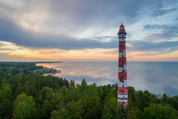 Obraz premium Osinovetsky lighthouse and Ladoga lake on summer sunset. Ladozhskoye Osero, Leningrad Oblast, Russia.