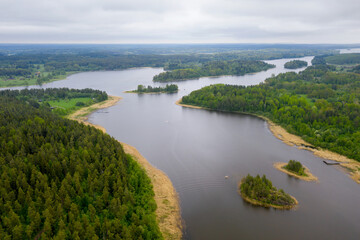 Aerial view of Kavantsalmi strait of Ladoga lake and Kilpola island (on the right) on cloudy summer day. Ladoga Skerries National park, Karelia, Russia.