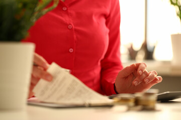 Businesswoman using calculator and financial checks conducts audit