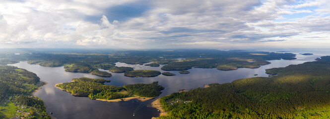 Panoramic aerial view of Yakimvarsky gulf of Ladoga lake on sunny summer evening. Surroundings of Sorola village, Karelia, Russia.