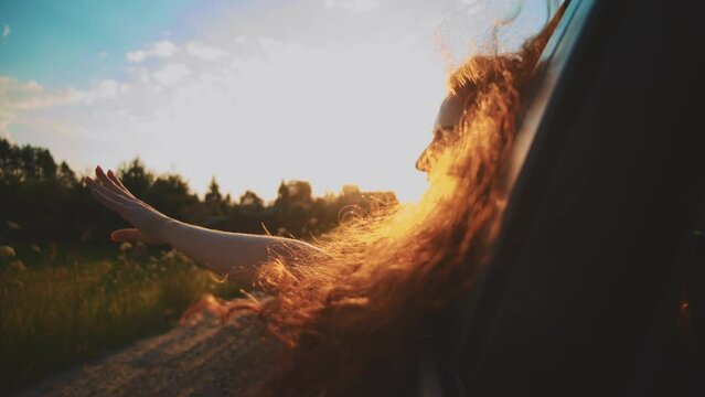 young woman travelling by car or camper van, open window breathe fresh air of countryside, Young smile woman driving car and looking around at road traffic of green city. Adult girl having safety ride