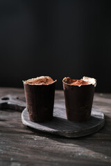Italian dessert tiramisu in glass made from chocolate. Traditional dessert from Italy. Tasty food. Dessert with mascarpone cheese.