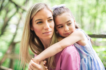 Fototapeta premium mother with his daughter having fun outside in forest