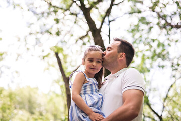 Fototapeta premium Father with his daughter having fun outside in forest